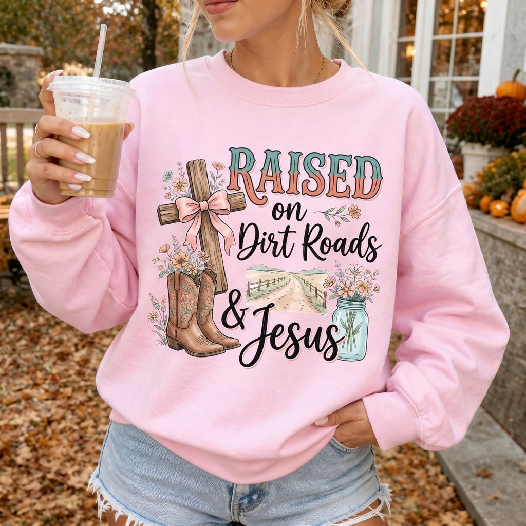 Woman wearing Raised on Dirt Roads & Jesus Christian sweatshirt in Light Pink