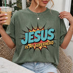 Woman wearing Jesus Is My Superhero Christian Comfort Colors T-Shirt in Moss