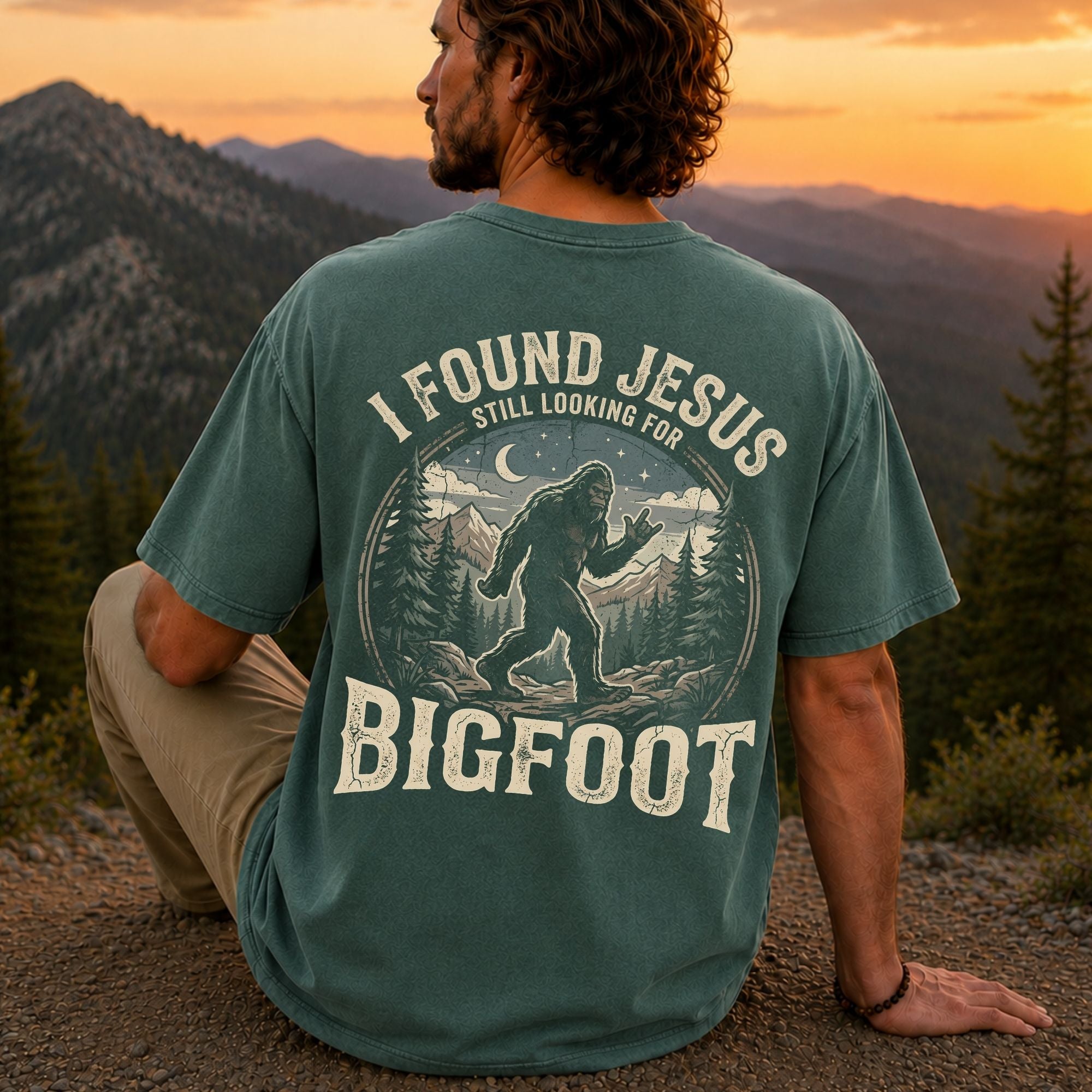 Man wearing I Found Jesus Still Looking for Bigfoot Christian Comfort Colors T-Shirt in Blue Spruce