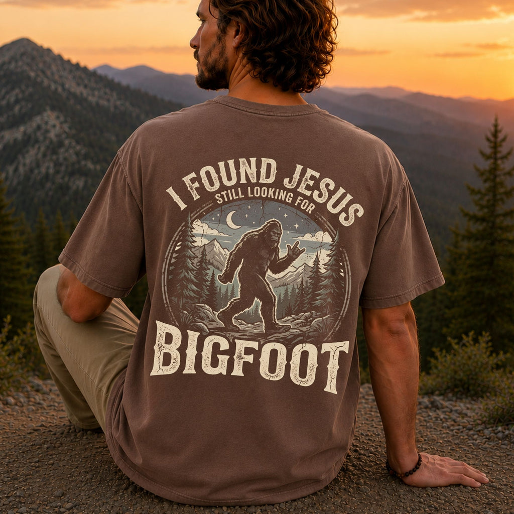 Man wearing I Found Jesus Still Looking for Bigfoot Christian Comfort Colors T-Shirt in Espresso
