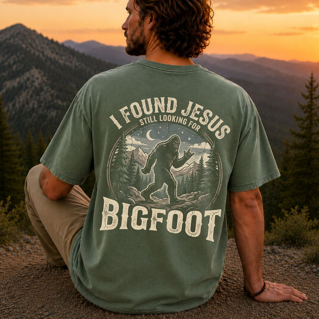 Man wearing I Found Jesus Still Looking for Bigfoot Christian Comfort Colors T-Shirt in Moss
