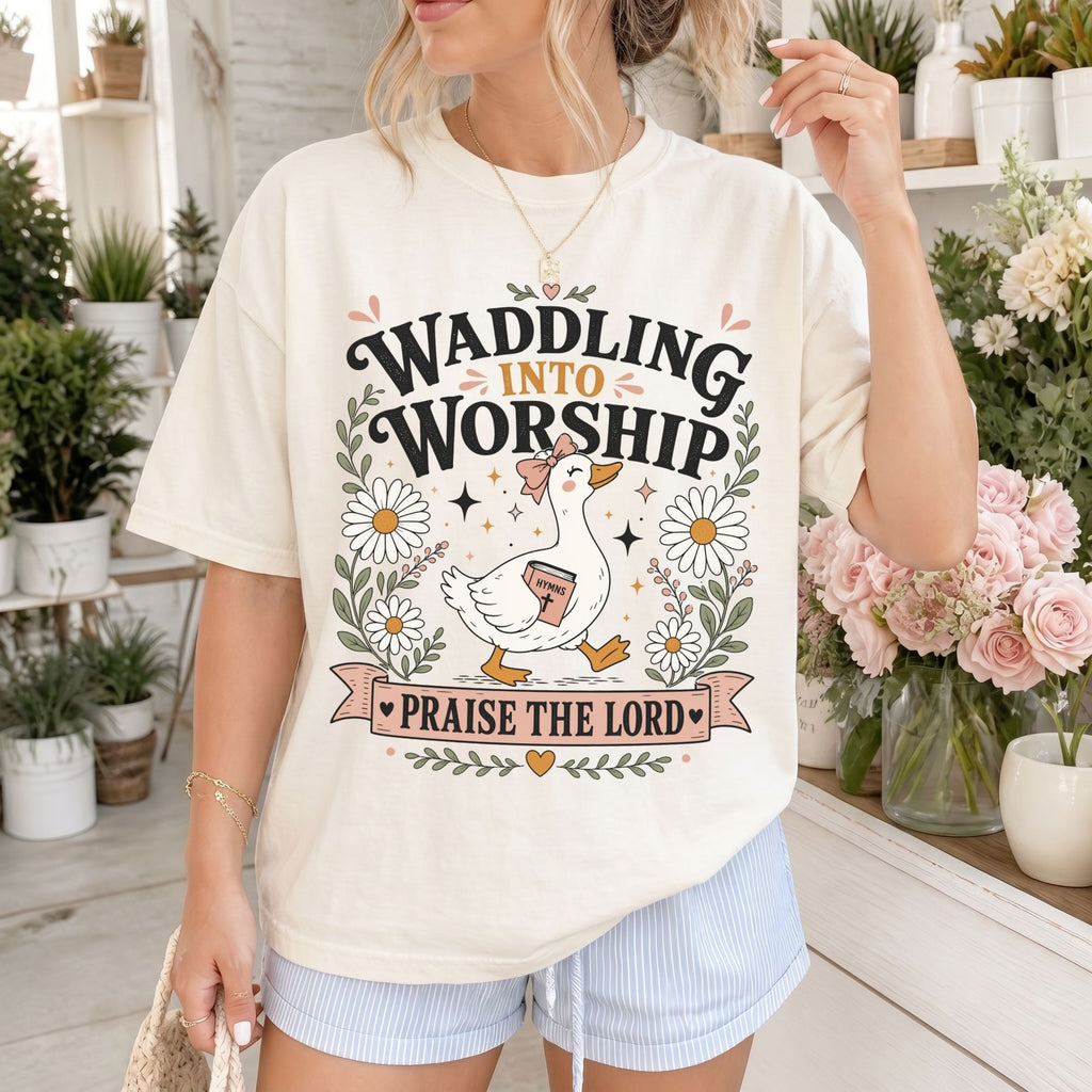 Woman wearing Waddling Into Worship Christian Comfort Colors T-Shirt in Ivory