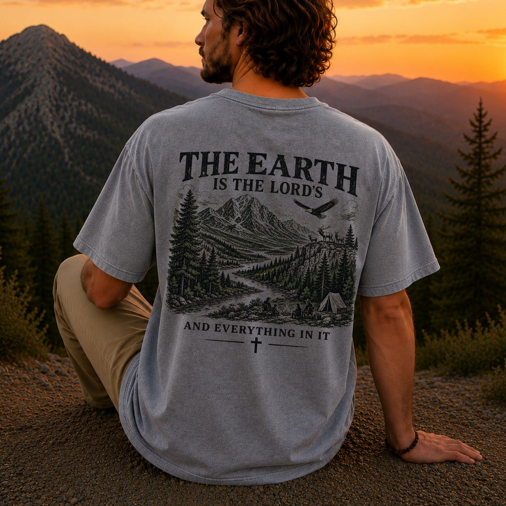 Man wearing The Earth Is the Lord's Christian Comfort Colors T-Shirt in Grey