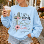 Woman wearing Give Thanks Believe Hope Christian sweatshirt in Light Blue