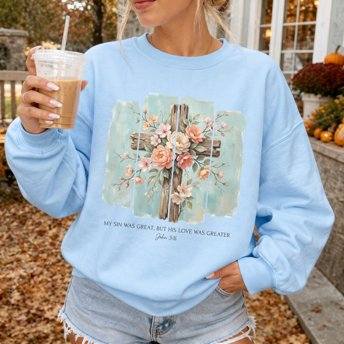 Woman wearing His Love Was Greater Christian sweatshirt in Light Blue