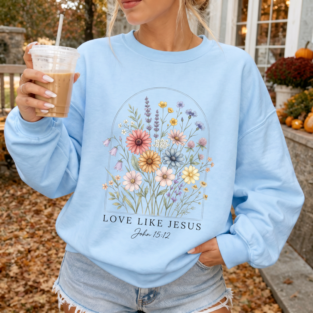 Woman wearing Love Like Jesus Christian sweatshirt in Light Blue