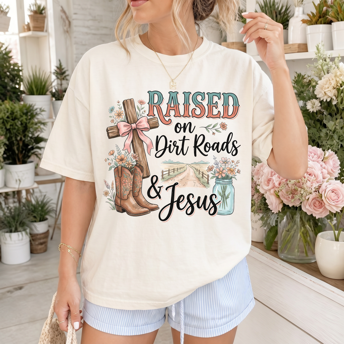 Woman wearing Raised on Dirt Roads & Jesus Christian Comfort Colors T-Shirt in Ivory