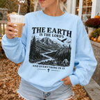 Woman wearing The Earth Is the Lord's Christian sweatshirt in Light Blue