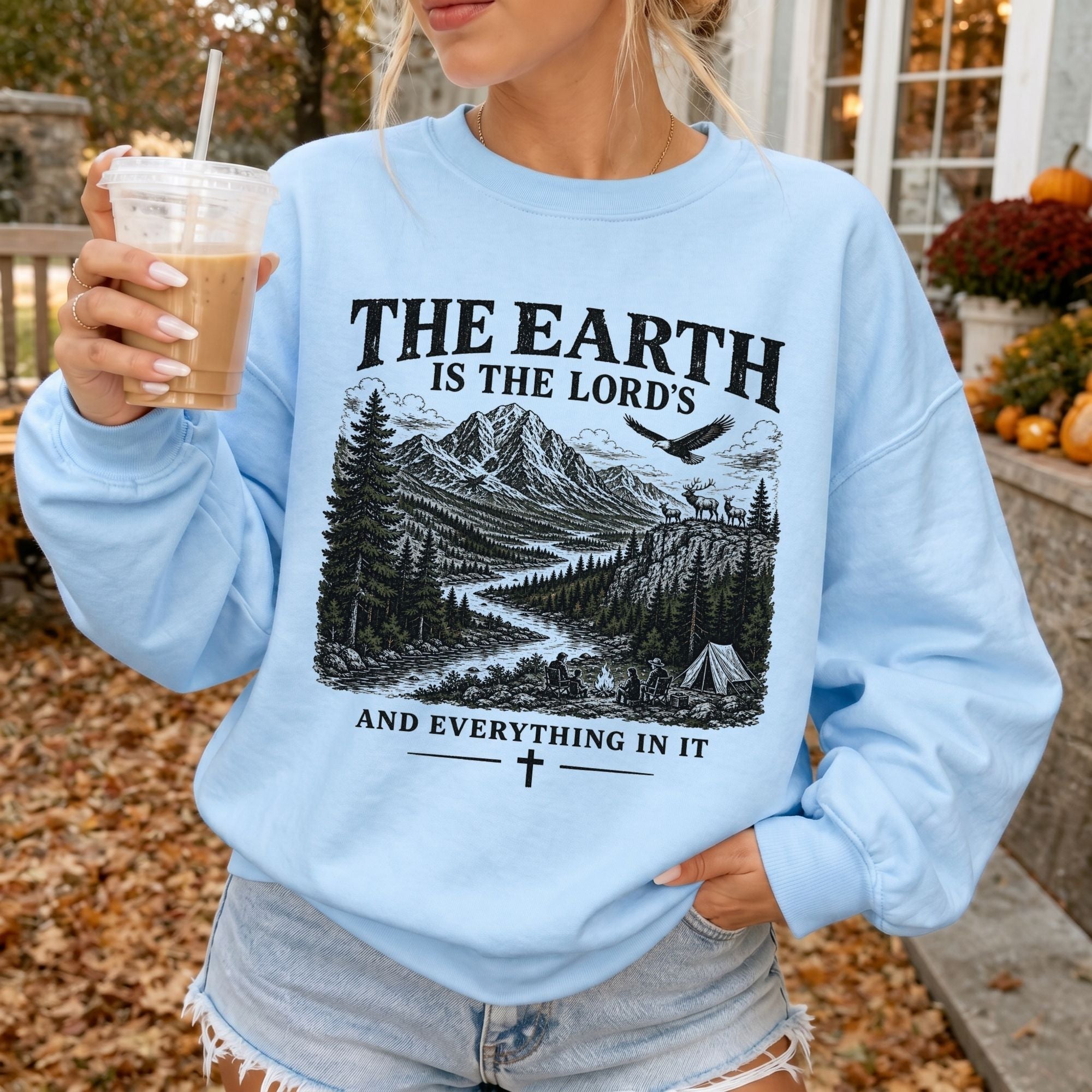 Woman wearing The Earth Is the Lord's Christian sweatshirt in Light Blue